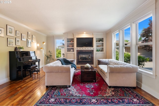 1046 NW Deerfern Loop, Camas, WA 98607 - living room with ornamental molding, healthy amount of natural light, a glass covered fireplace, and wood finished floors