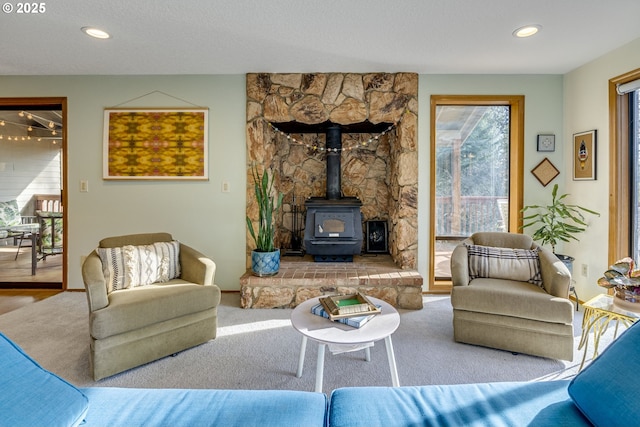 living room featuring carpet floors and a wood stove