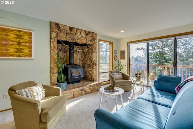 carpeted living room with a textured ceiling and a wood stove