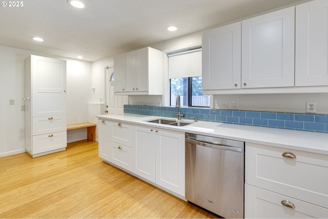 kitchen featuring sink, stainless steel dishwasher, and white cabinets