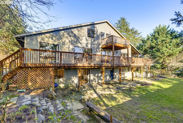 back of house with a wooden deck and a lawn