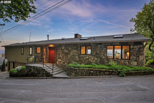 3110 NW Monte Vista Ter, Portland, OR 97210 - single story home with a chimney, stone siding, and a garage