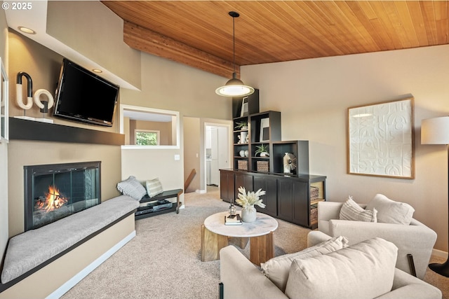3110 NW Monte Vista Ter, Portland, OR 97210 - living room featuring carpet flooring, a glass covered fireplace, baseboards, a towering ceiling, and wood ceiling