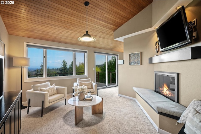 3110 NW Monte Vista Ter, Portland, OR 97210 - interior space featuring light carpet, a glass covered fireplace, baseboards, vaulted ceiling, and wood ceiling