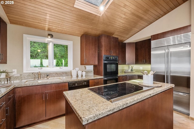 3110 NW Monte Vista Ter, Portland, OR 97210 - kitchen featuring wood ceiling, a kitchen island, a sink, black appliances, and lofted ceiling with skylight