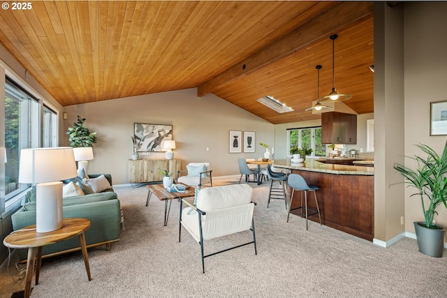 3110 NW Monte Vista Ter, Portland, OR 97210 - living area with light colored carpet, lofted ceiling with beams, wood ceiling, and baseboards