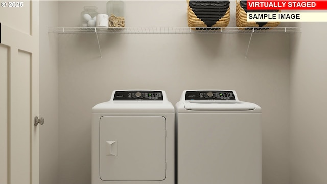 laundry area featuring washing machine and clothes dryer