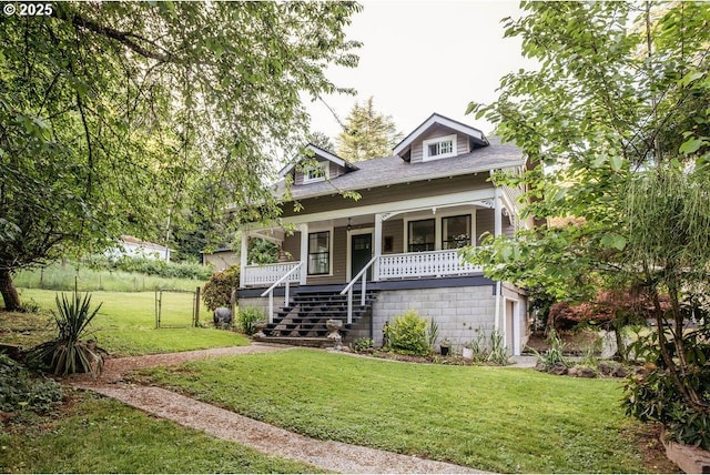 301 W Walnut St, Winlock, WA 98596 - bungalow featuring a front yard, a porch, stairs, and an attached garage