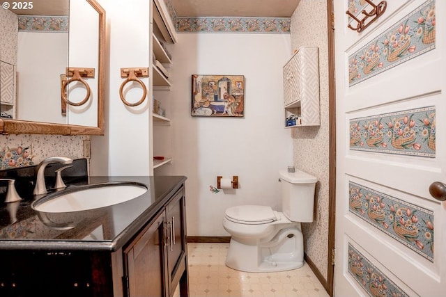 301 W Walnut St, Winlock, WA 98596 - bathroom with vanity, toilet, baseboards, and tile patterned floors