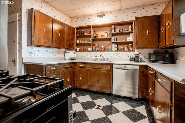 301 W Walnut St, Winlock, WA 98596 - kitchen with stainless steel dishwasher, dark floors, wallpapered walls, open shelves, and light countertops