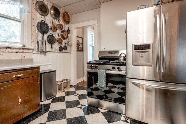 301 W Walnut St, Winlock, WA 98596 - kitchen with stainless steel appliances, dark flooring, wainscoting, and light countertops