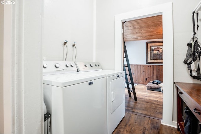 301 W Walnut St, Winlock, WA 98596 - laundry area featuring washing machine and dryer, wood walls, dark wood finished floors, wainscoting, and wooden ceiling