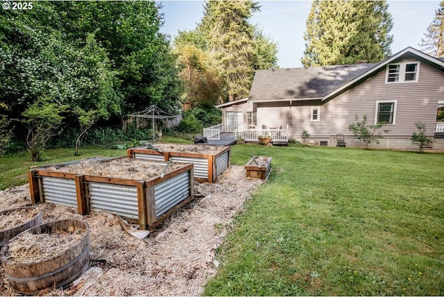 301 W Walnut St, Winlock, WA 98596 - view of green lawn featuring a vegetable garden and a wooden deck