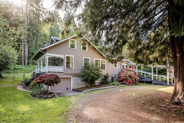 301 W Walnut St, Winlock, WA 98596 - view of front of property featuring driveway, a garage, a front lawn, and cooling unit