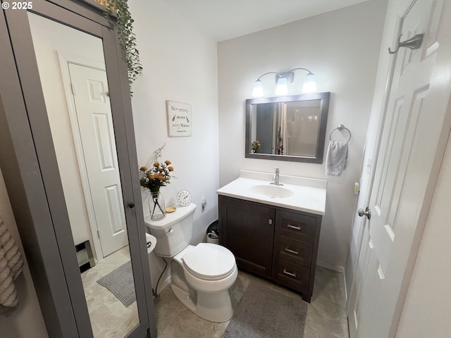 405 1st St, La Grande, OR 97850 - bathroom with toilet, vanity, and baseboards