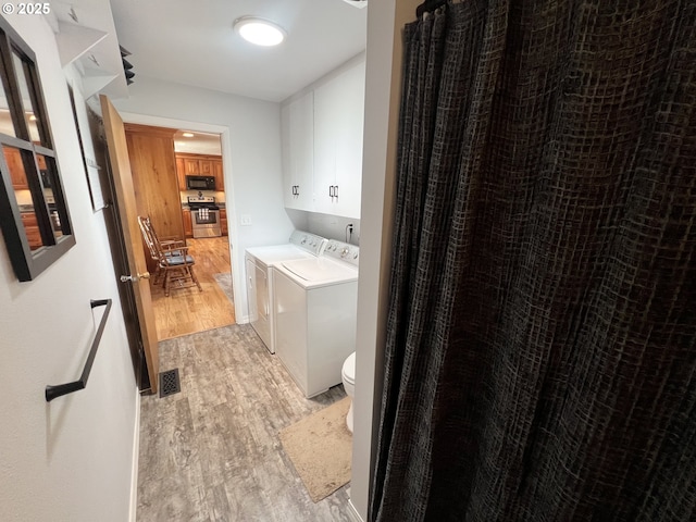 405 1st St, La Grande, OR 97850 - clothes washing area with washing machine and clothes dryer and light wood finished floors