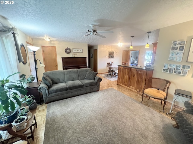 405 1st St, La Grande, OR 97850 - living room with a ceiling fan, a textured ceiling, and baseboards