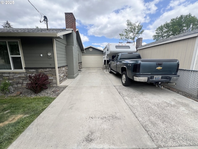 405 1st St, La Grande, OR 97850 - view of home's exterior with a chimney, stone siding, and an outbuilding