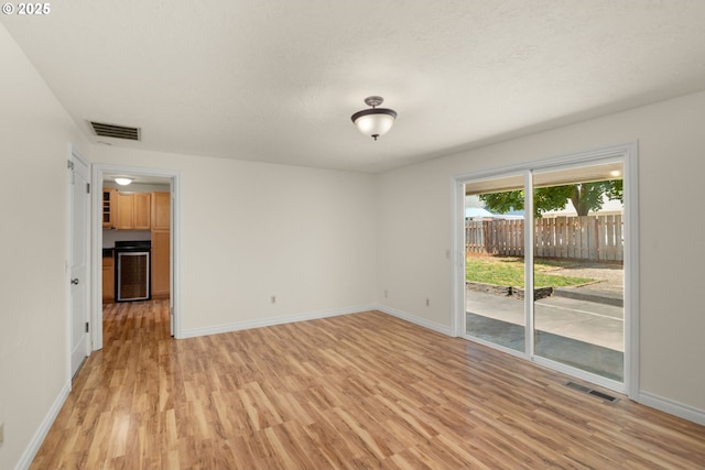 2235 SE Willow Ct, Hillsboro, OR 97123 - unfurnished room with light wood finished floors and wine cooler
