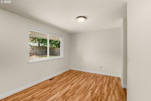 2235 SE Willow Ct, Hillsboro, OR 97123 - empty room with light wood-type flooring and a textured ceiling