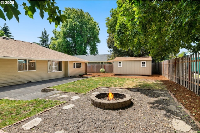 2235 SE Willow Ct, Hillsboro, OR 97123 - fenced backyard featuring a fire pit, a patio area, and a storage shed