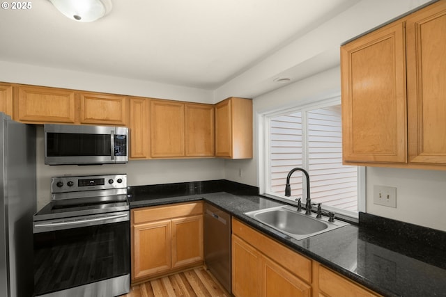 2235 SE Willow Ct, Hillsboro, OR 97123 - kitchen with appliances with stainless steel finishes, light wood-style floors, and dark stone counters