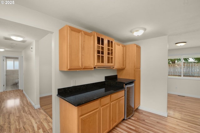 2235 SE Willow Ct, Hillsboro, OR 97123 - kitchen with light wood-style flooring, glass insert cabinets, light brown cabinets, and dishwashing machine