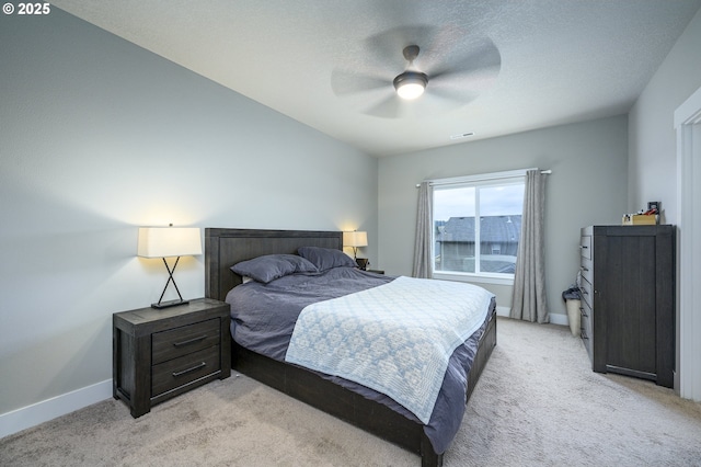 bedroom featuring light carpet, baseboards, and ceiling fan