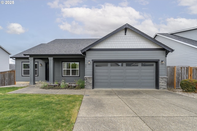 view of front of home featuring a garage, concrete driveway, roof with shingles, and stone siding