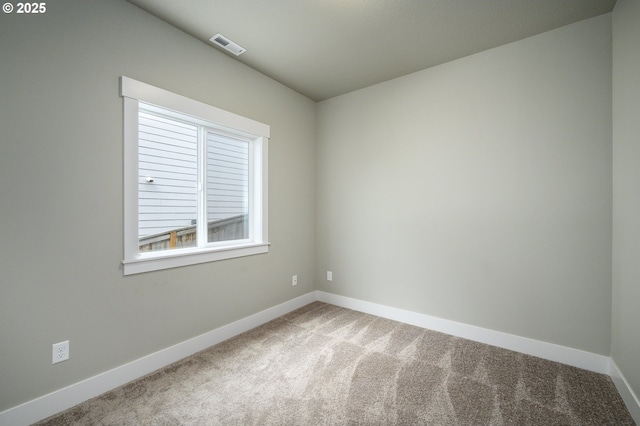spare room with carpet floors and baseboards