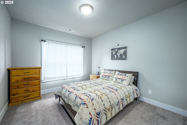bedroom with carpet floors, baseboards, and a textured ceiling