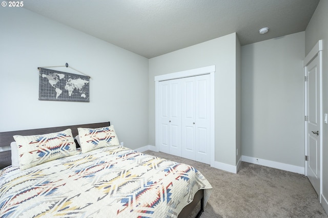bedroom with carpet floors, a closet, and baseboards