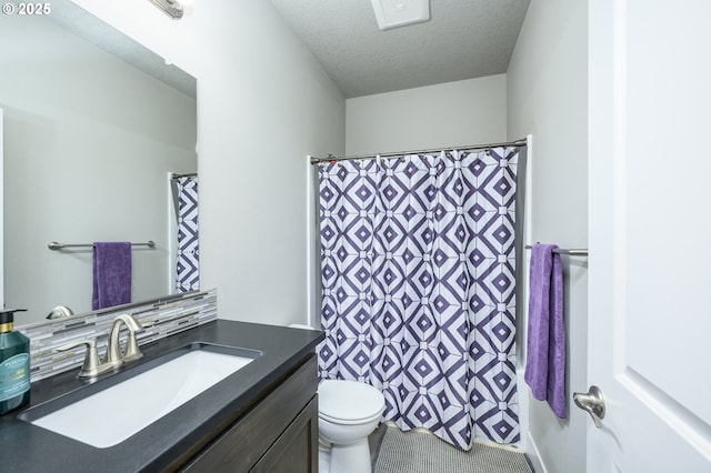 full bathroom featuring vanity, toilet, a textured ceiling, and a shower with shower curtain