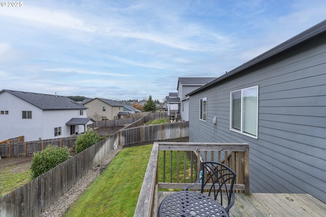 view of yard featuring a deck and a residential view