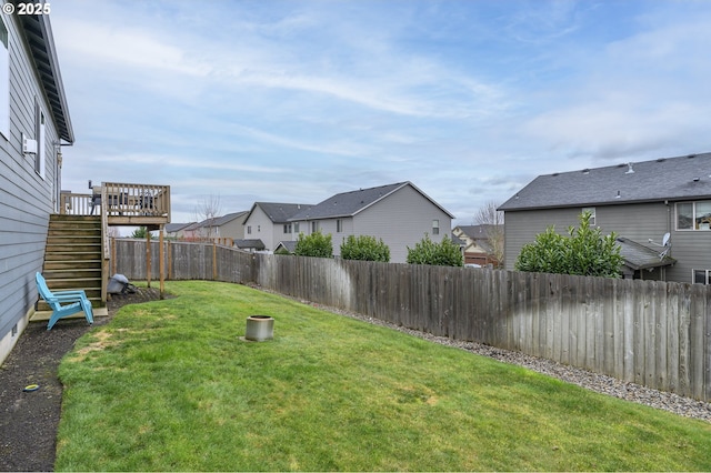 view of yard with stairway, a deck, and a residential view