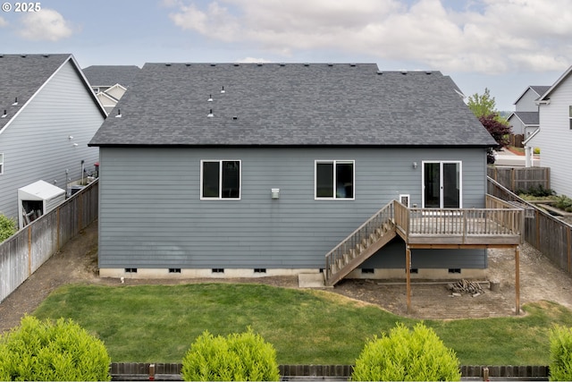 rear view of property featuring a shingled roof, a wooden deck, and stairs