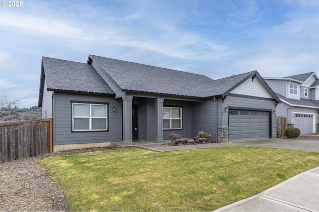 view of front of house with asphalt driveway, an attached garage, and roof with shingles