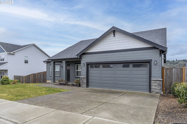 view of front of property with an attached garage, driveway, a shingled roof, and stone siding