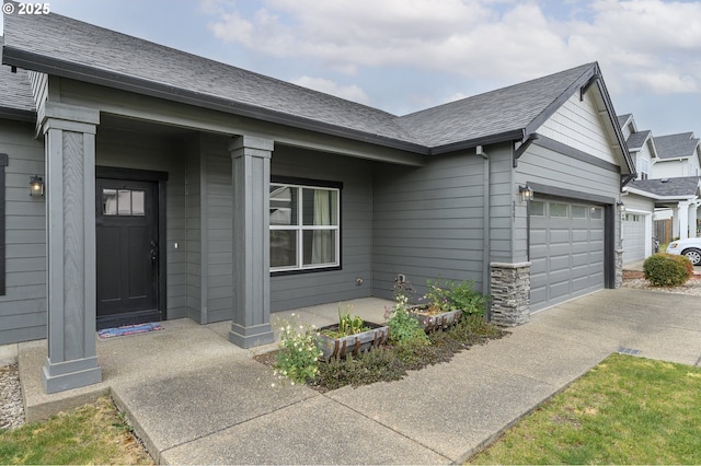 view of front facade featuring a garage, concrete driveway, and a shingled roof