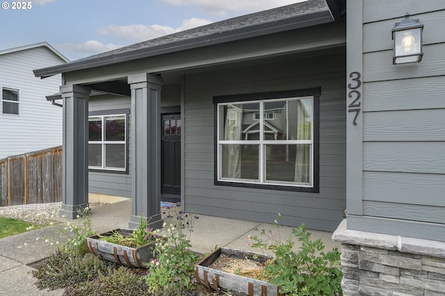 property entrance featuring fence and a porch
