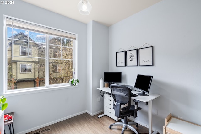 office featuring visible vents, wood finished floors, and baseboards