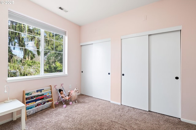 recreation room featuring visible vents and carpet floors