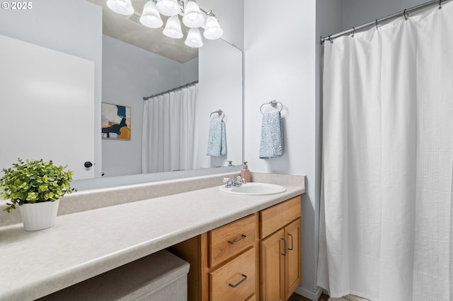 bathroom with an inviting chandelier and vanity