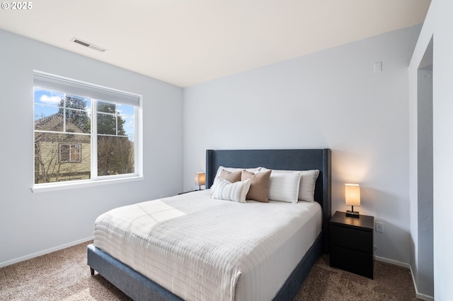 bedroom featuring visible vents, baseboards, and dark colored carpet