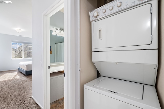 laundry room with laundry area, stacked washer and clothes dryer, and carpet floors