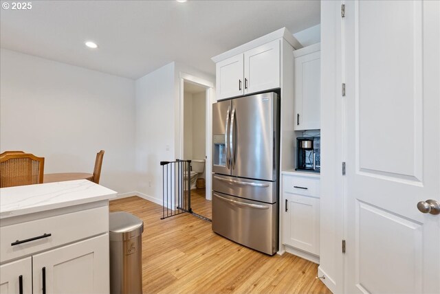 16615 SE Sunshower Pl, Happy Valley, OR 97086 - kitchen featuring stainless steel refrigerator with ice dispenser, light wood finished floors, white cabinets, light stone counters, and recessed lighting