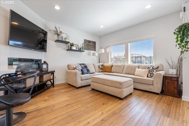 16615 SE Sunshower Pl, Happy Valley, OR 97086 - living room with light wood finished floors, recessed lighting, baseboards, and a glass covered fireplace