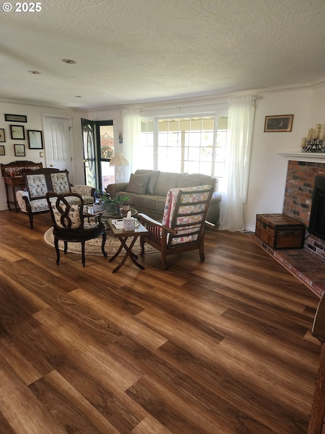 living area featuring a healthy amount of sunlight, a textured ceiling, and dark wood-type flooring