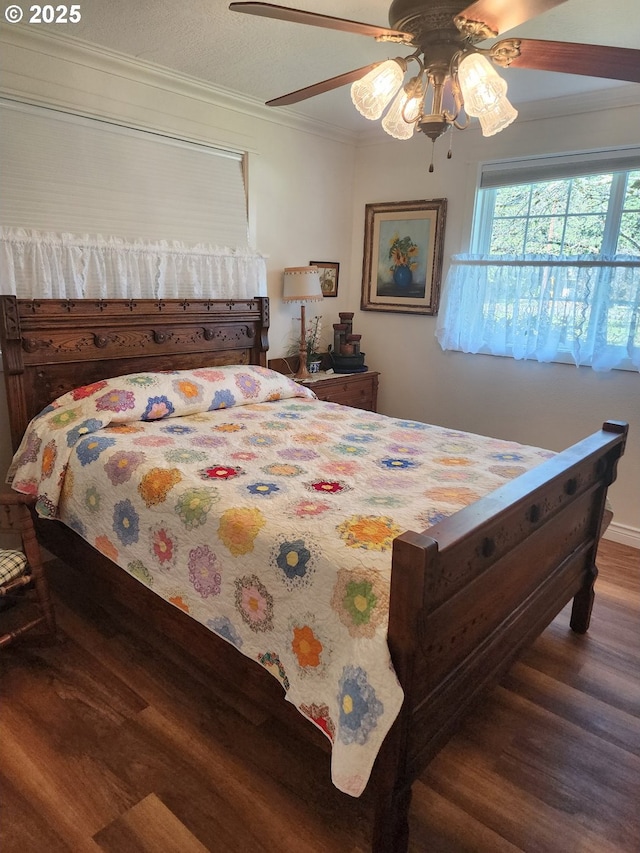 bedroom featuring ceiling fan, wood finished floors, and ornamental molding