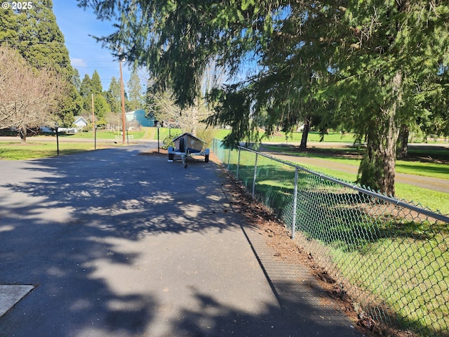 view of home's community featuring fence